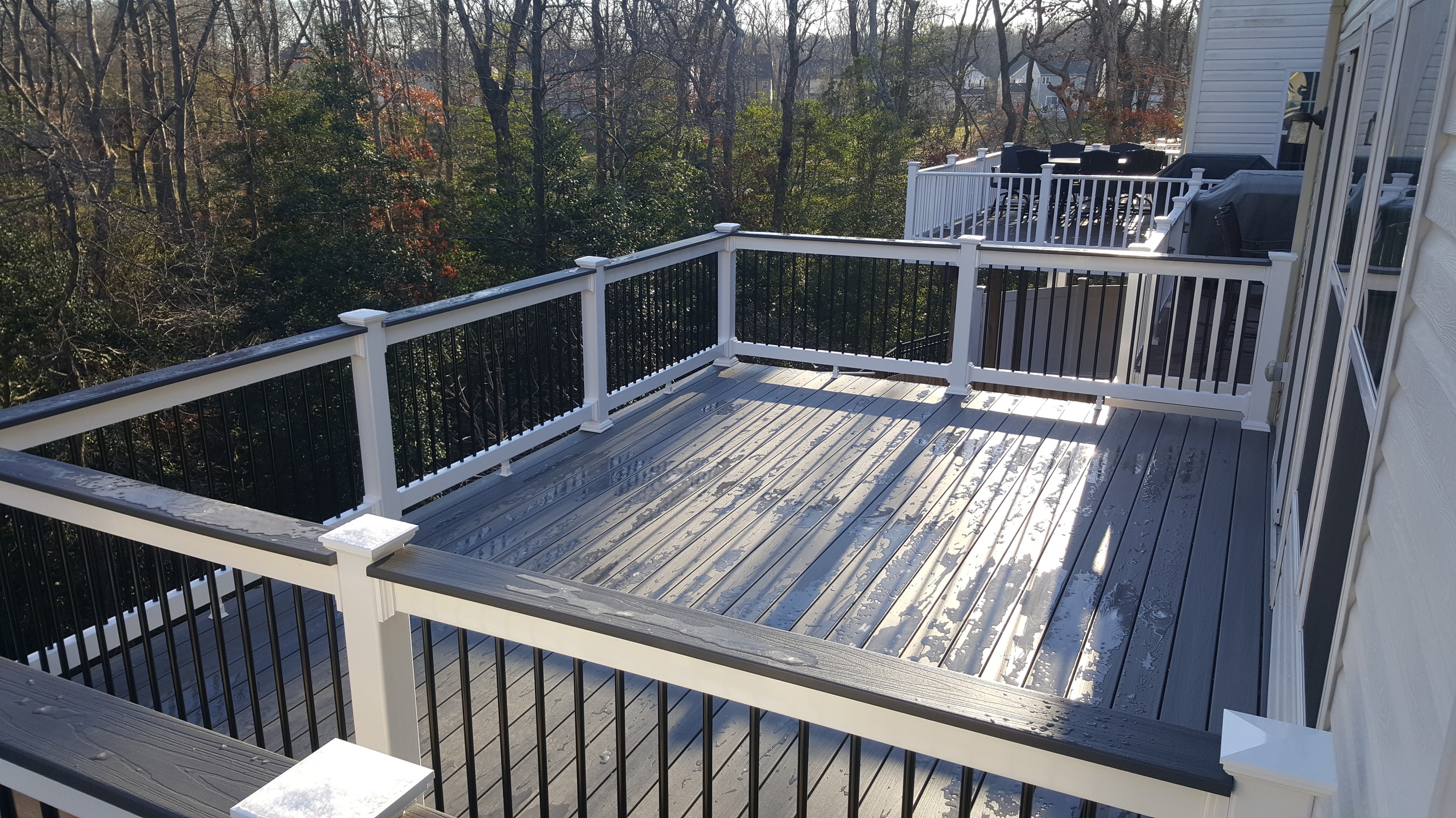 Fiberon Gray Birch decking, Monument rails with Black Aluminum Balusters and Decking toppers. Tiger claw hidden fasteners. 