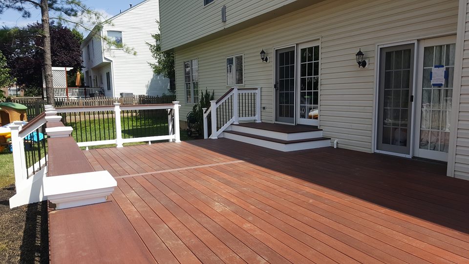 Cinnabar Fiberon Symmetry Decking with a landing/platform step out from house.