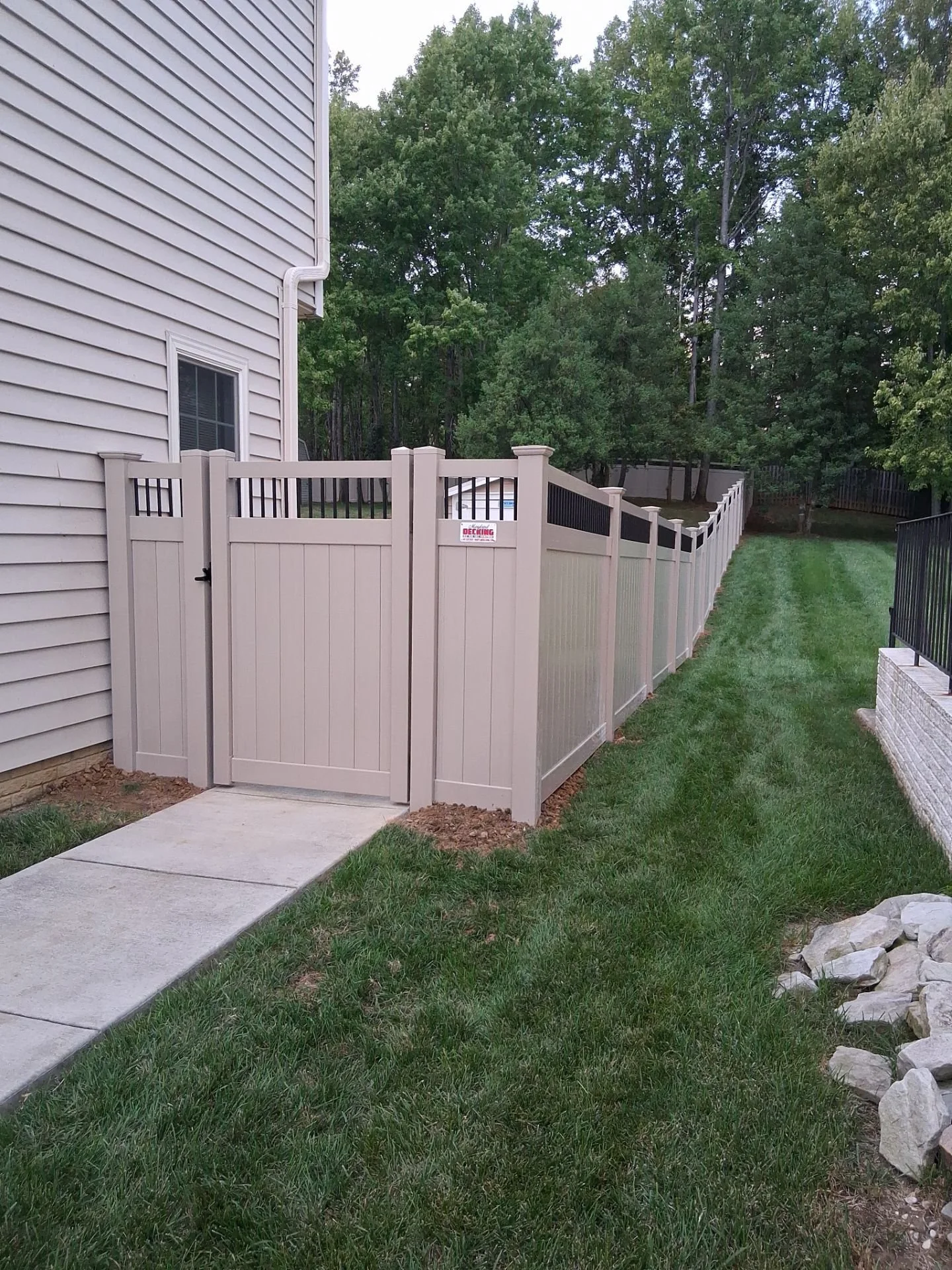Tan Vinyl Fence with Black Spindle Top