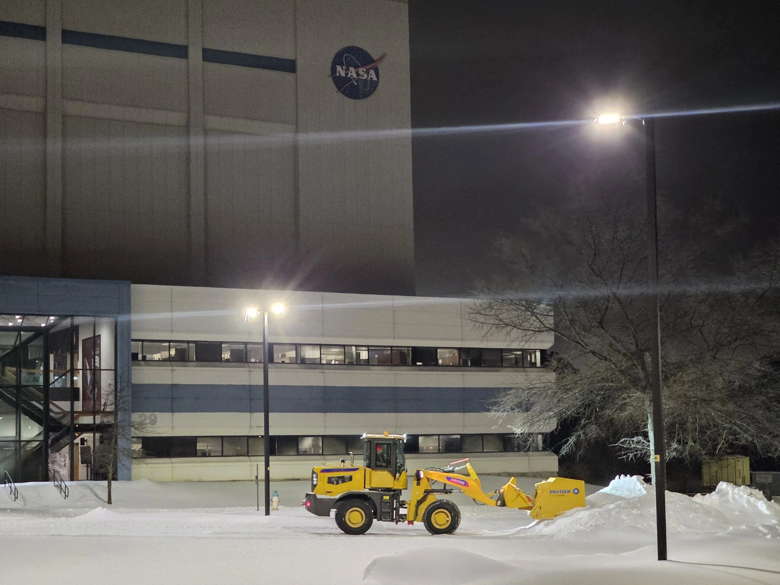 Loader plows snow at NASA for Maryland decking