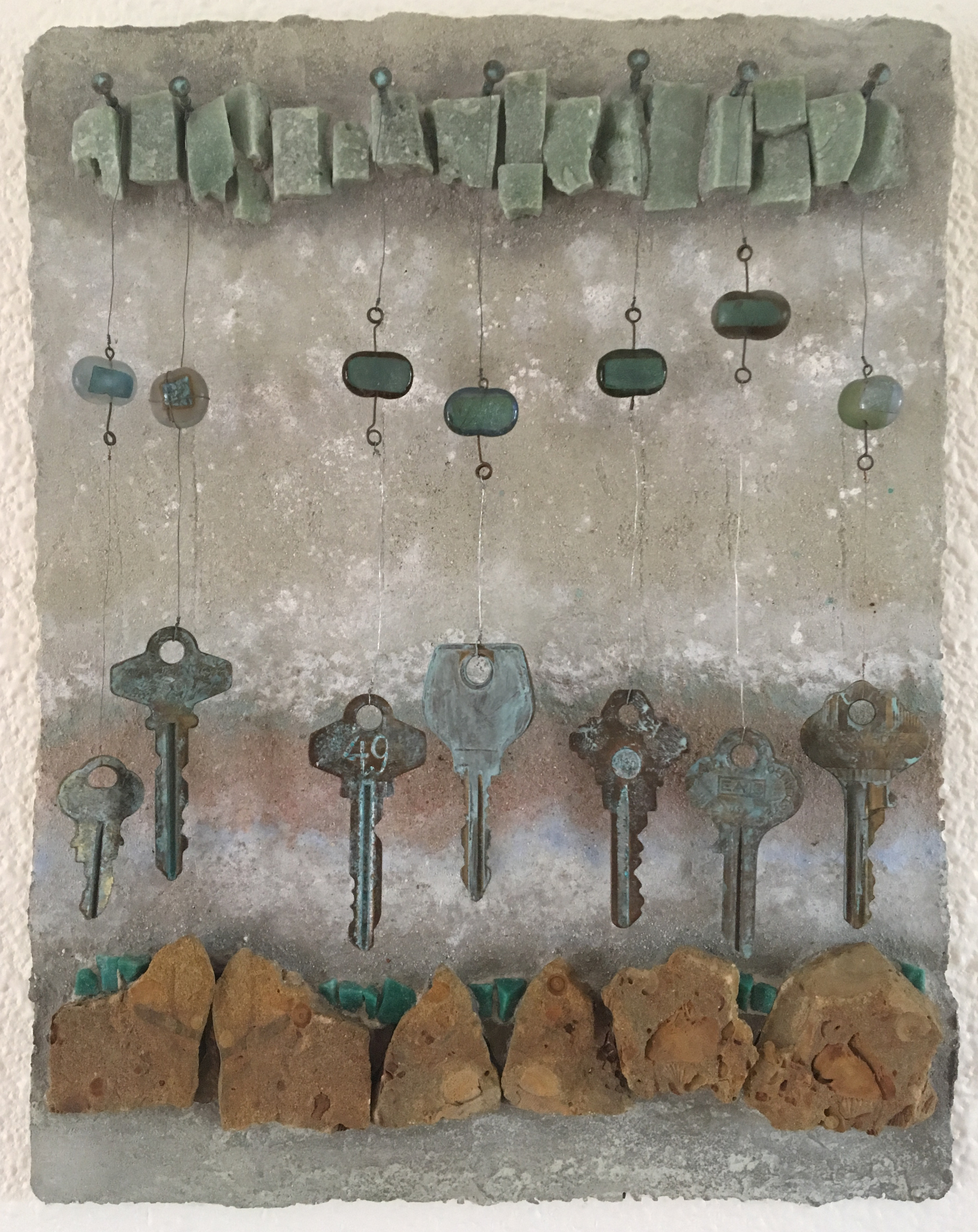  Travel Notes ( sold )  Keys, glass, stone, and pigment on hand formed cement panel  11 inches high x 8.5 inches wide 