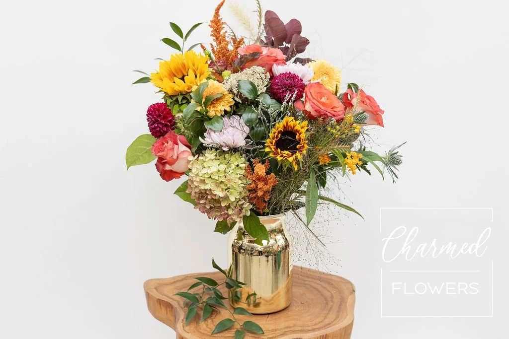 fall flowers in a gold vase