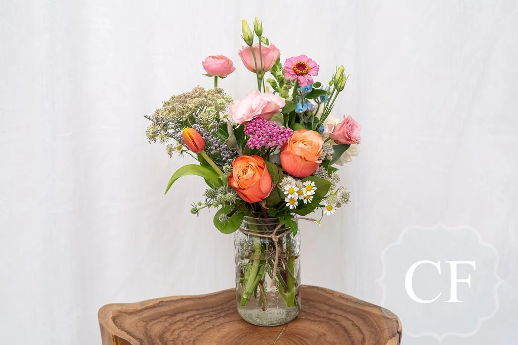 Beautiful Pink Peach and Orange Flowers Arranged in a Jar