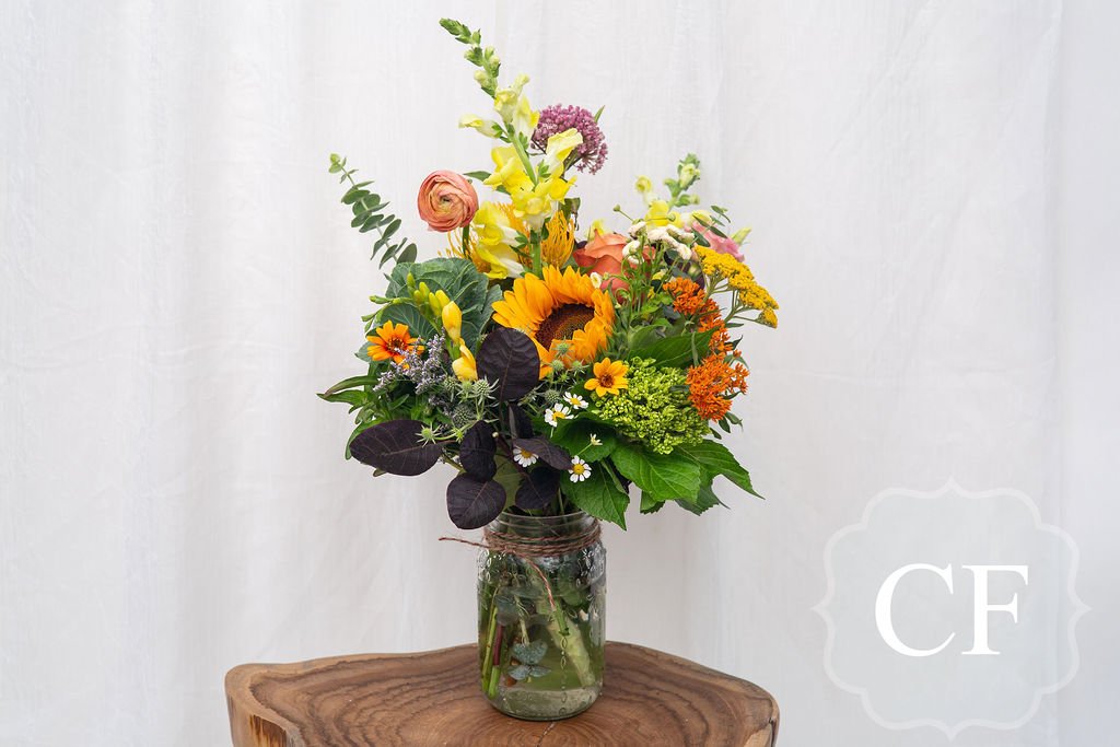 Yellow Bright Colourful Seasonal Flowers Arranged in a Jar