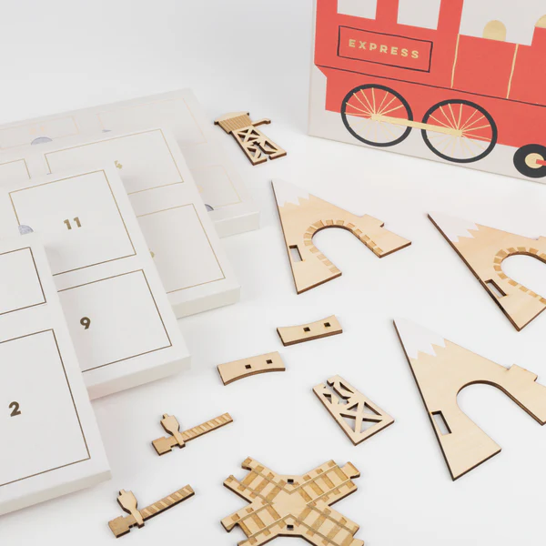 Train themed advent calender peices including railroad tracks and tunnel