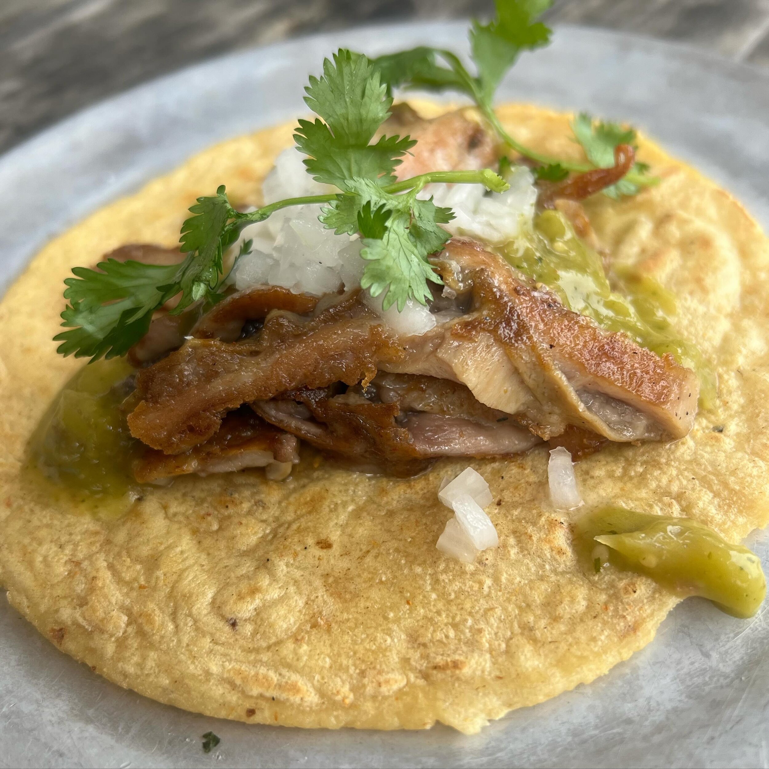 Buche (pork stomach) Taco is on! One of our favorite tacos of all time. So simple, crispy pork, white onion, cilantro and salsa verde.  The classics are classics for a reason!