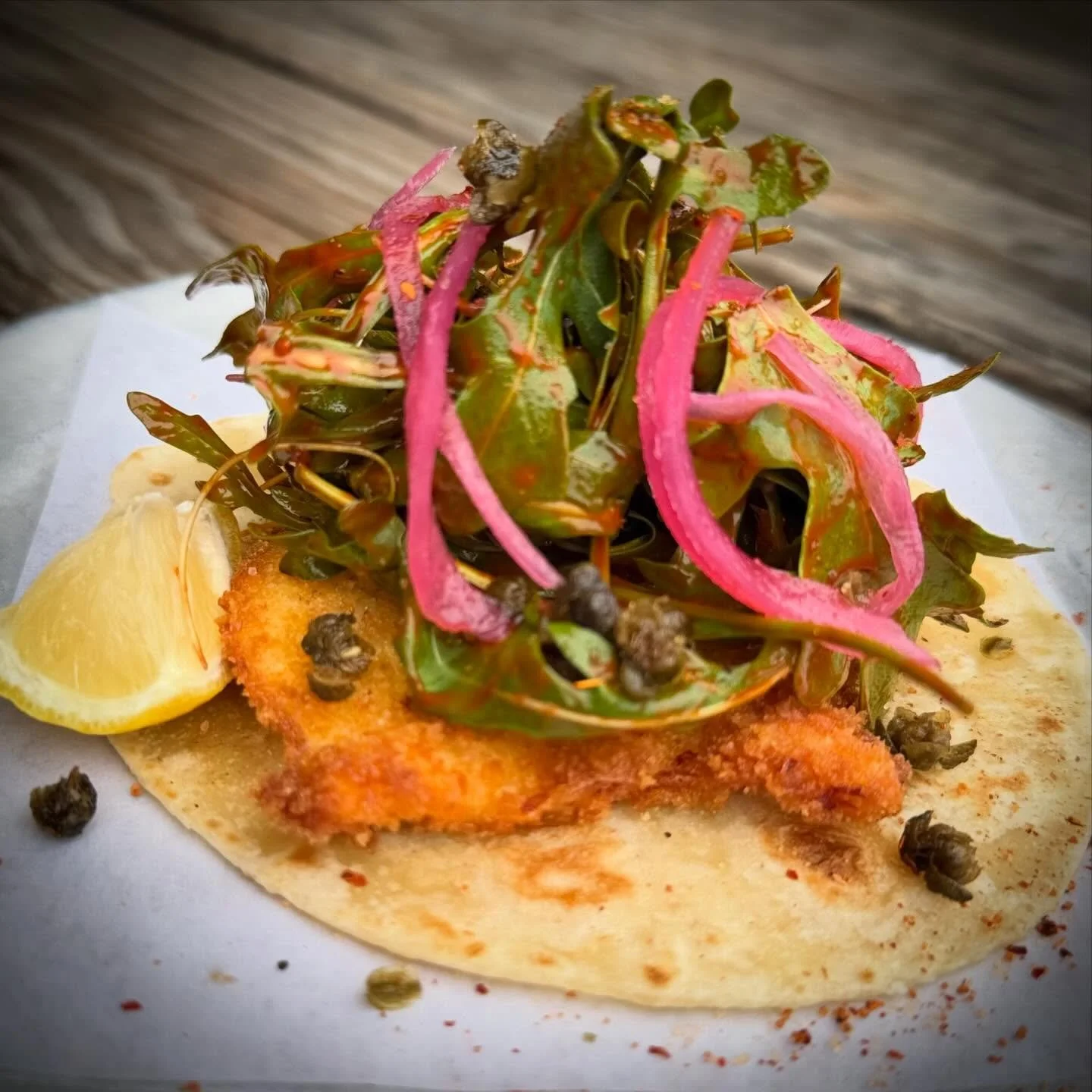 Chicken Paillard Taco / Baby Arugula, Pickled Red Onion, Fried Capers, Ancho Vinaigrette