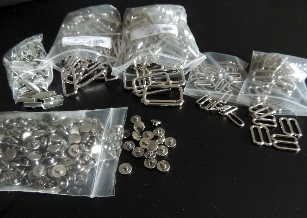 ^Lots of silver notions: Rectangle adjusters/slider thingies - these are used in the adjustable straps in both types of JSKs; ribbon crimpies - (I don't know why I find these so cute, but they are) these are of course used for the ends of the waist ties; lastly, the silver buttons used throughout the series. (I believe I also got a hella ton of headbands in this week as well, but it slipped my mind to get a picture.)