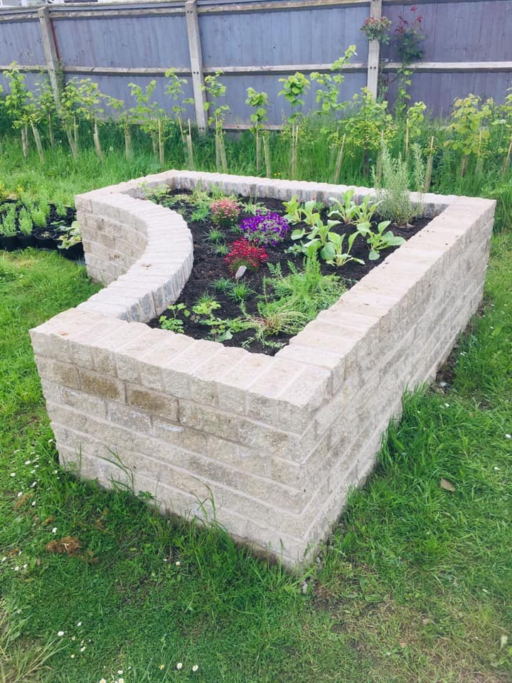 brick raised beds with plants.jpg