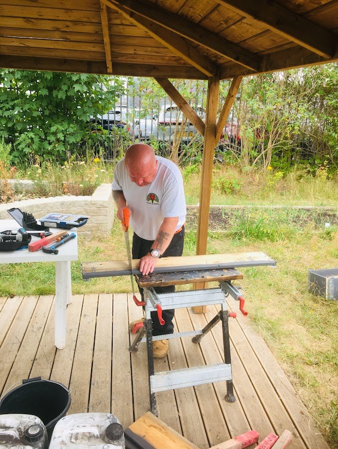 carpenter making garden planter from recycled pallet wood.jpg