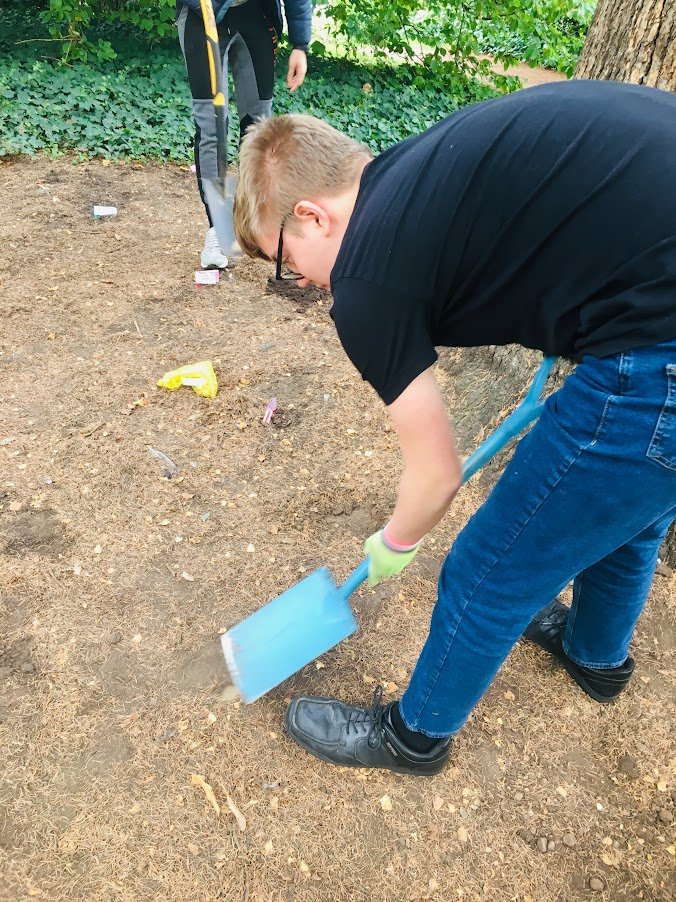 Welcombe hills school pupil digging soil.JPG