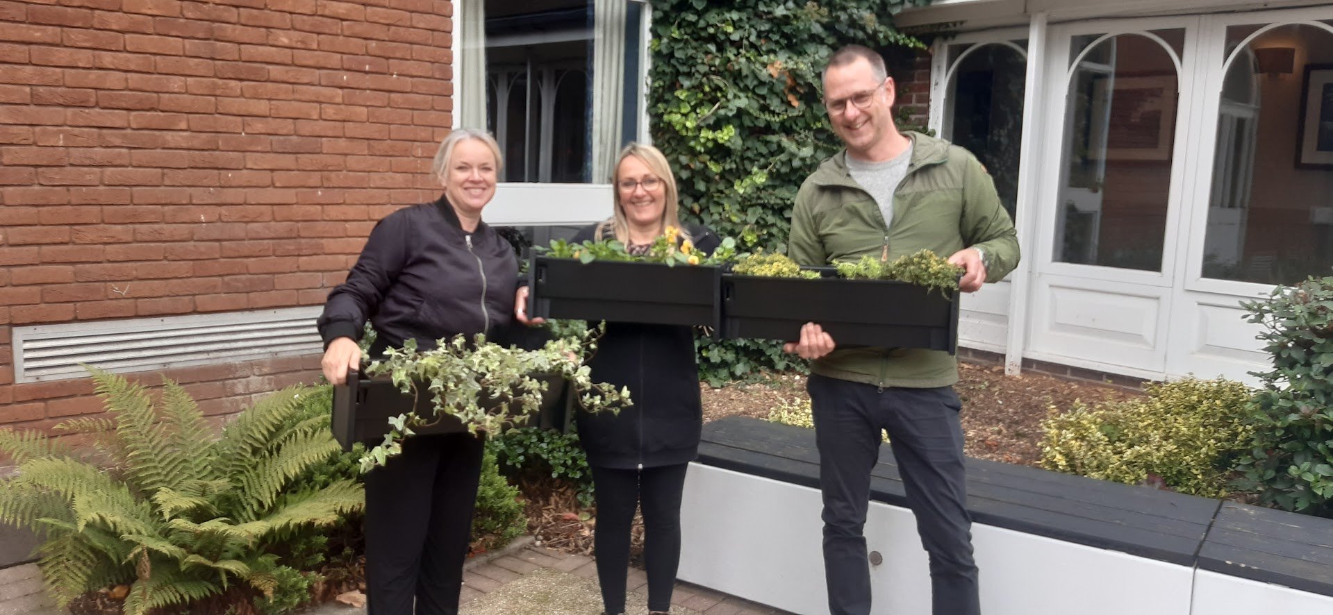 Institute of Employability Professionals employees with living wall planters.jpg