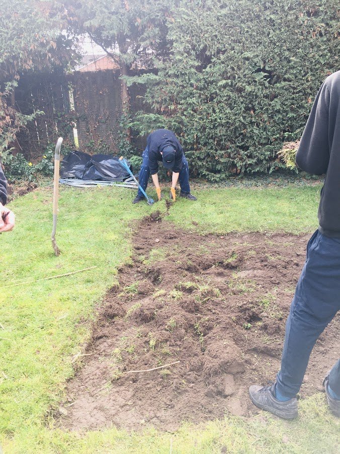 volunteers digging flower bed.JPG