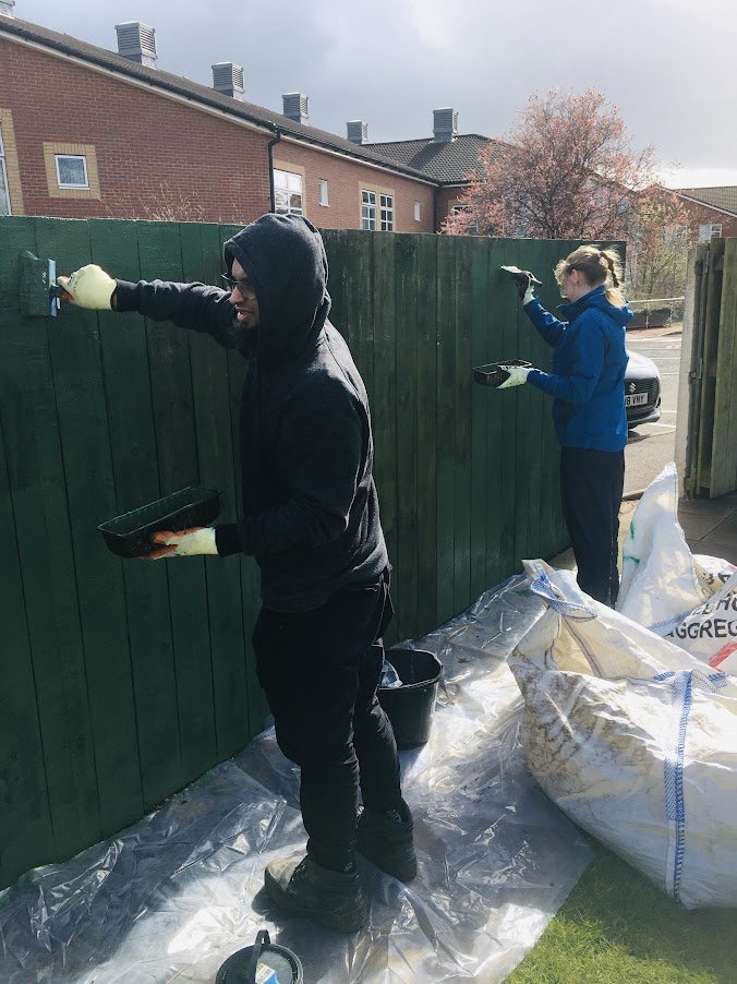 volunteers painting garden fence.JPG