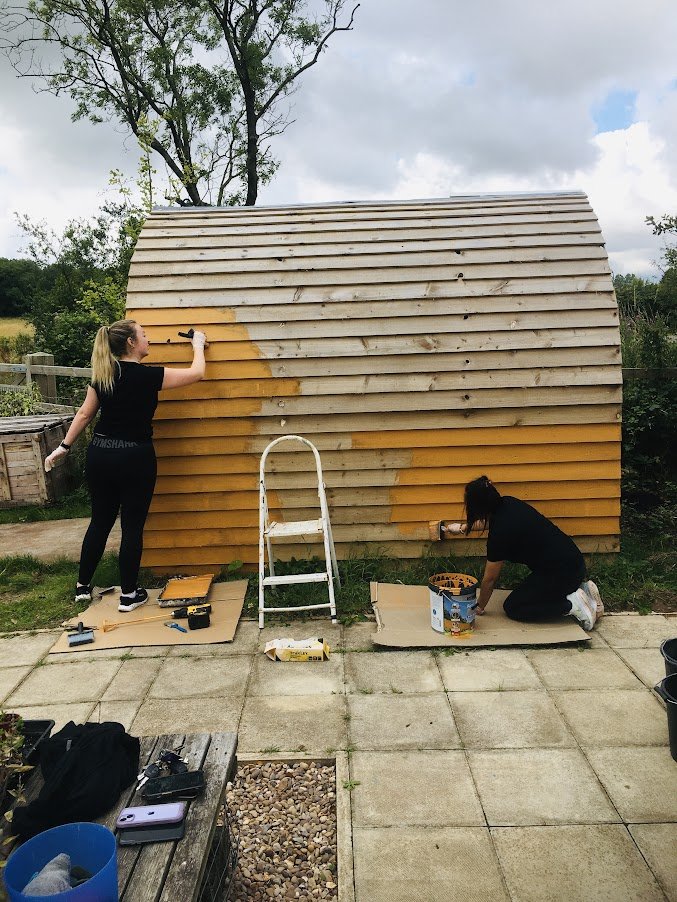 volunteers painting compost toilet.JPG