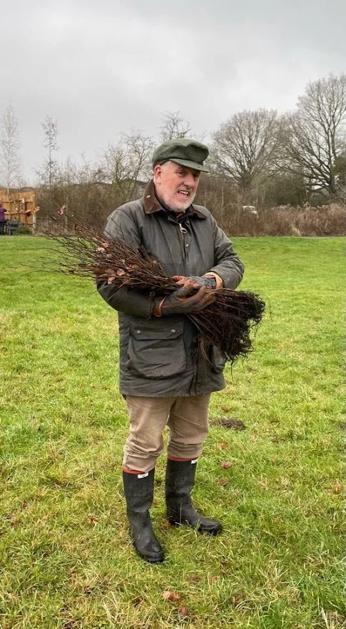 volunteer with tree saplings during tree planting event.jpg