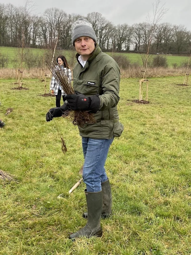 community volunteer holding tree saplings.jpg