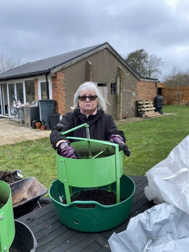 volunteering using a green compost sieve.jpg