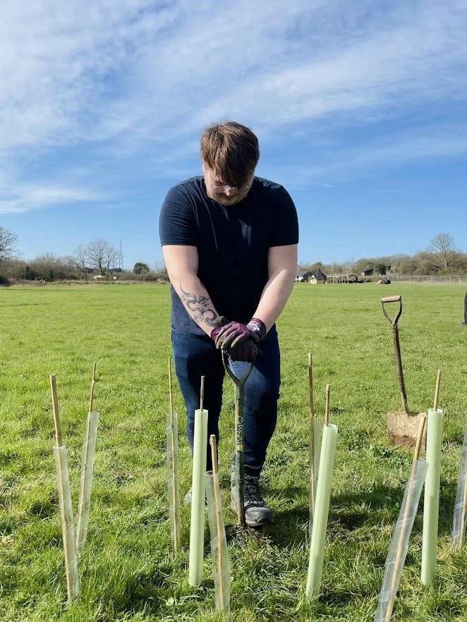 corporate volunteer digging to plant trees.jpg