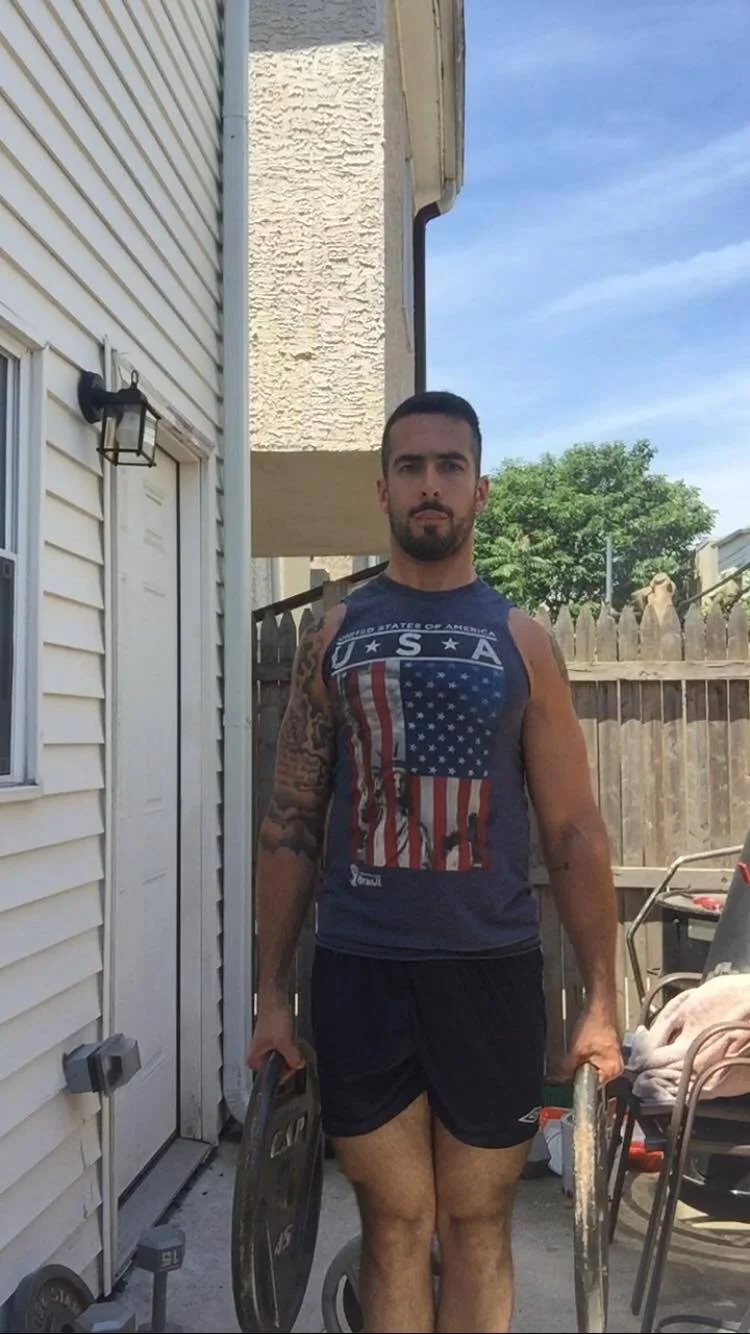 The starting point for a Farmer's Walk using two weight plates.
