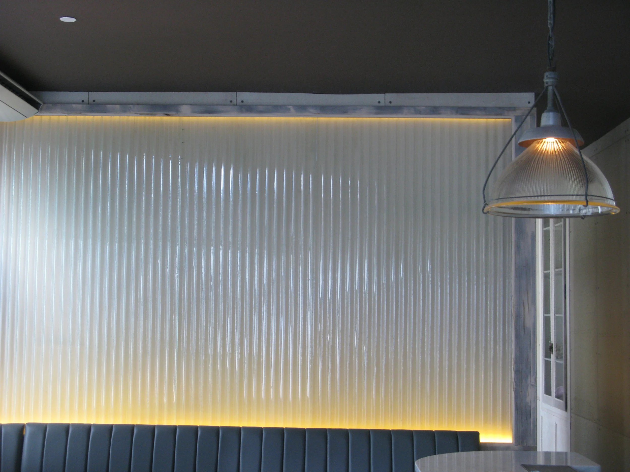  One section of back-lit wall installation. Ssel Rose, NYC. Reclaimed corrugated glass and reclaimed ebonized maple. 