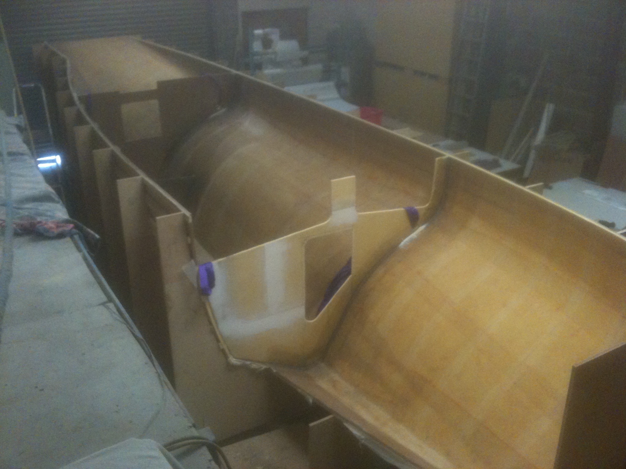 Strips of foam are heated and forced into shape, screwed to the mould and glassed over