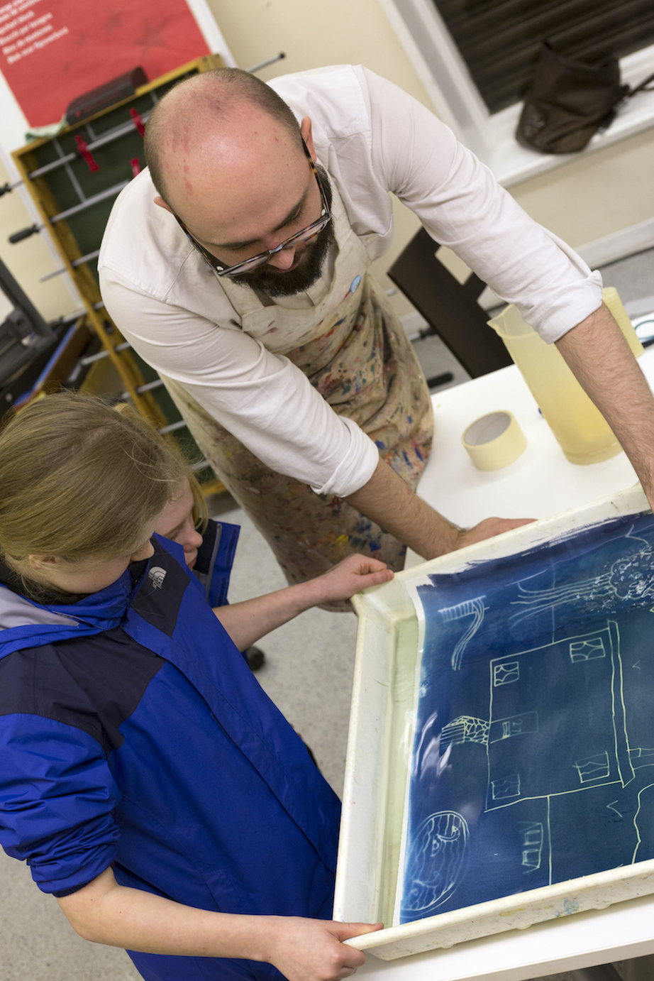 developing the plans into real blueprints (or cyanotypes) using a chemical solution