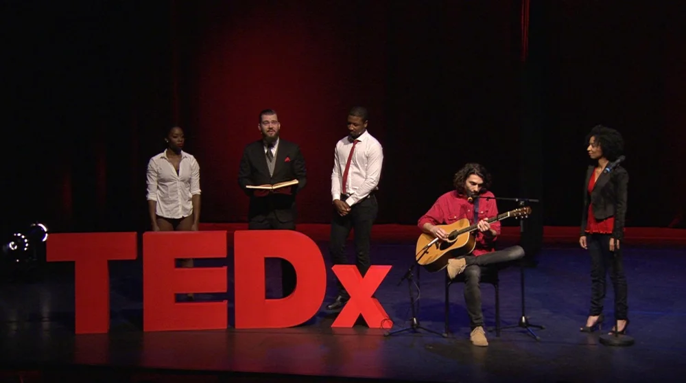 Playing guitar at a TEDx cross-arts performance, Oude Luxor Theater Rotterdam