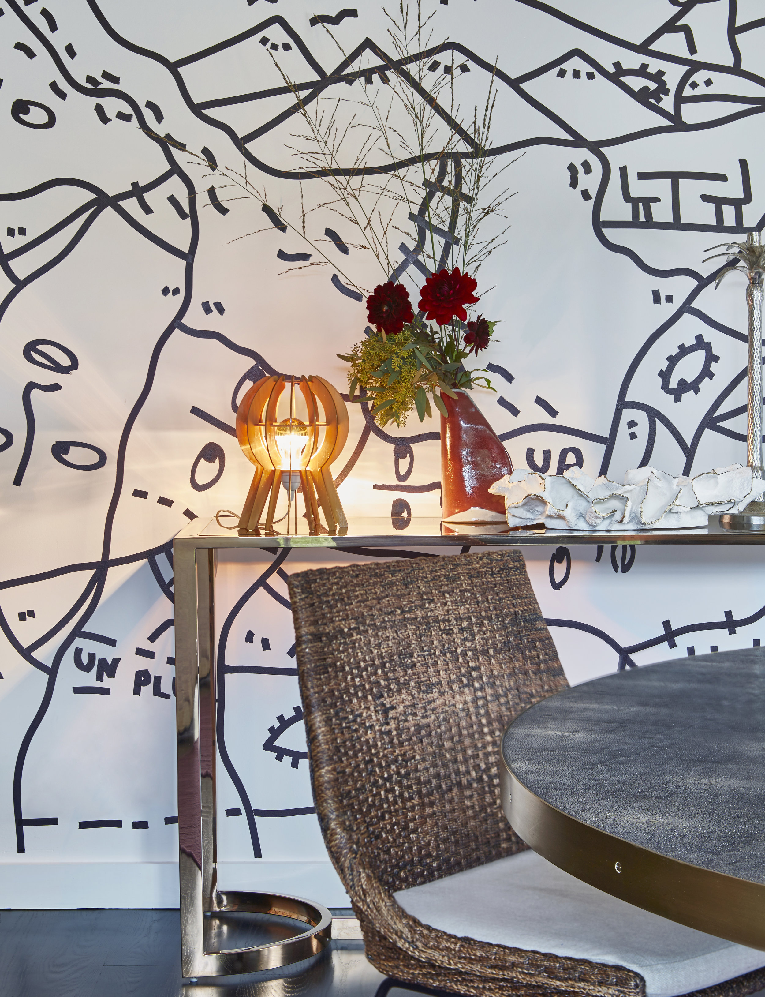 Custom wall painting/mural by Shantell Martin. Tall chairs: Handwoven river reed chairs made in Thailand.