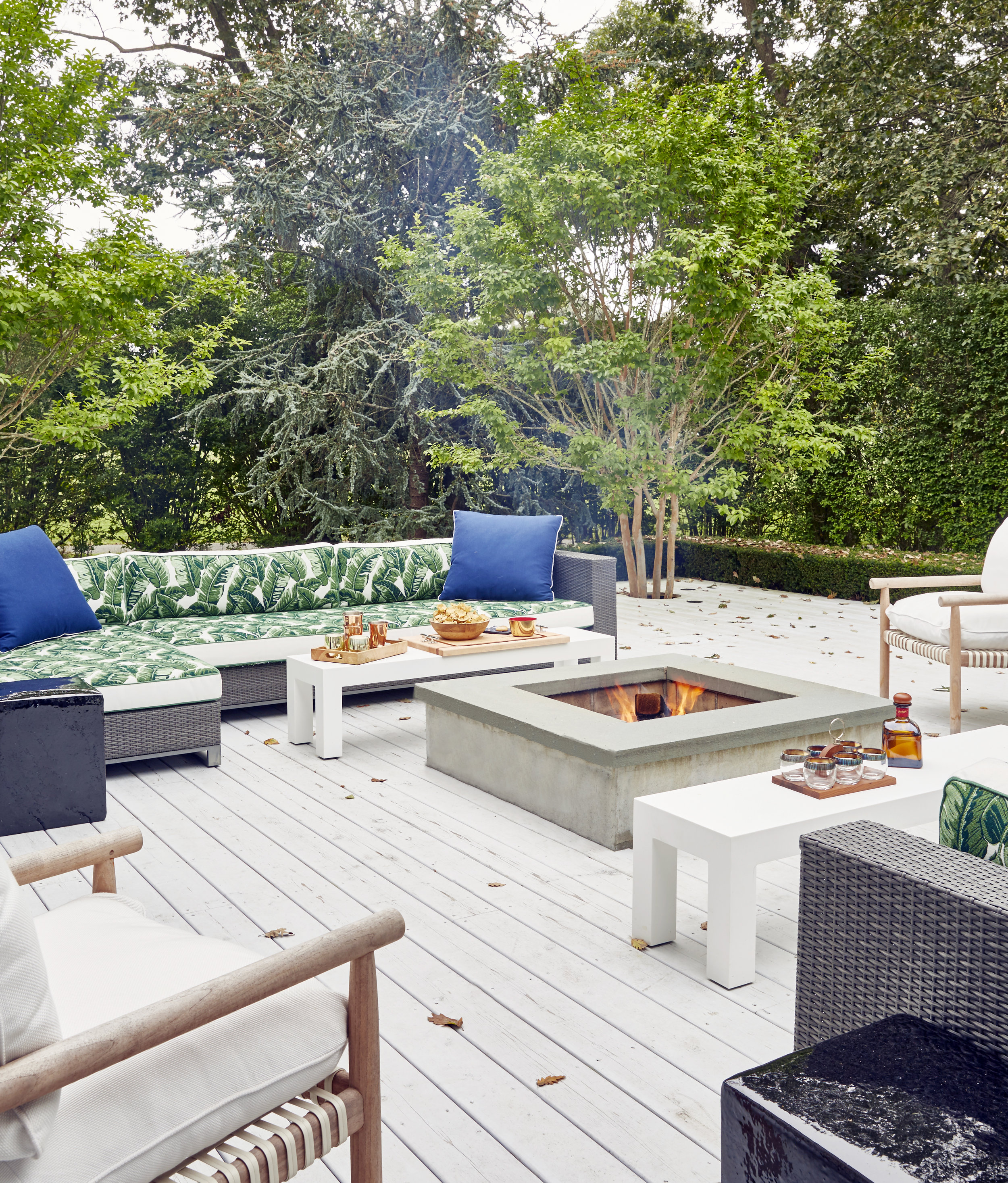Sofas from Restoration hardware, armchairs &amp; dining chairs DEDON, rocking chairs Janus et cie, green leaf fabric Pierre Frey, Custom white corian tables designed by Aamir Khandwala, custom firepit