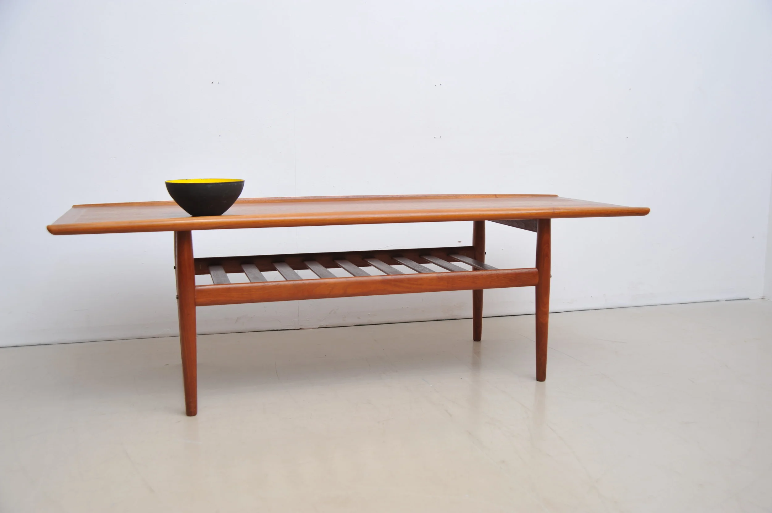 grete-jalk-couchtisch-tisch-coffee-table-teak-braun-rand-surfboard-zeitungsablage-mit- schale.JPG