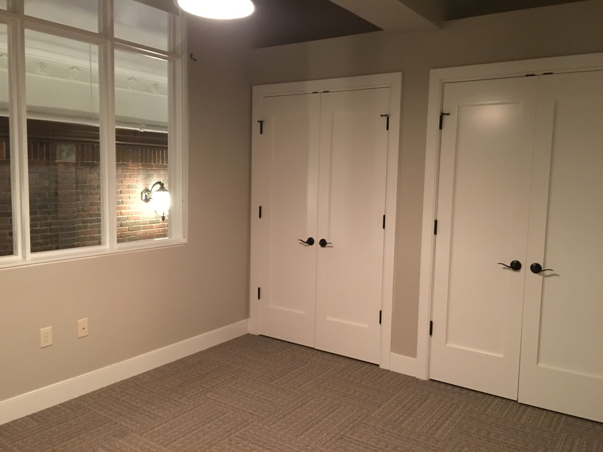 Second floor master bedroom with a window overlooking the hallway.