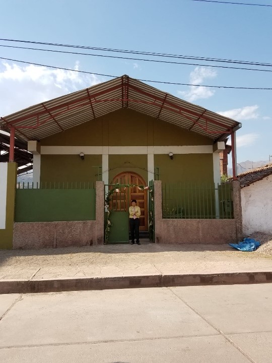 Pastor Celestino in front of Huacarpay Mennonite Church