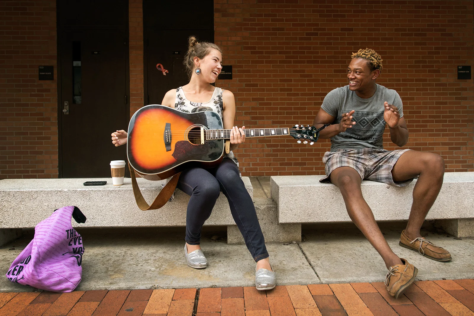 Students play guitar and sing near the Old Student Union.