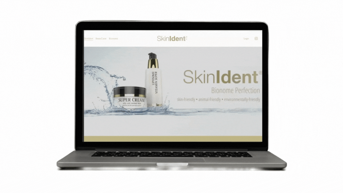 Laptop displaying a skincare product website named SkinIdent with bottles of super cream and vital ultra serum in a splash of water background.