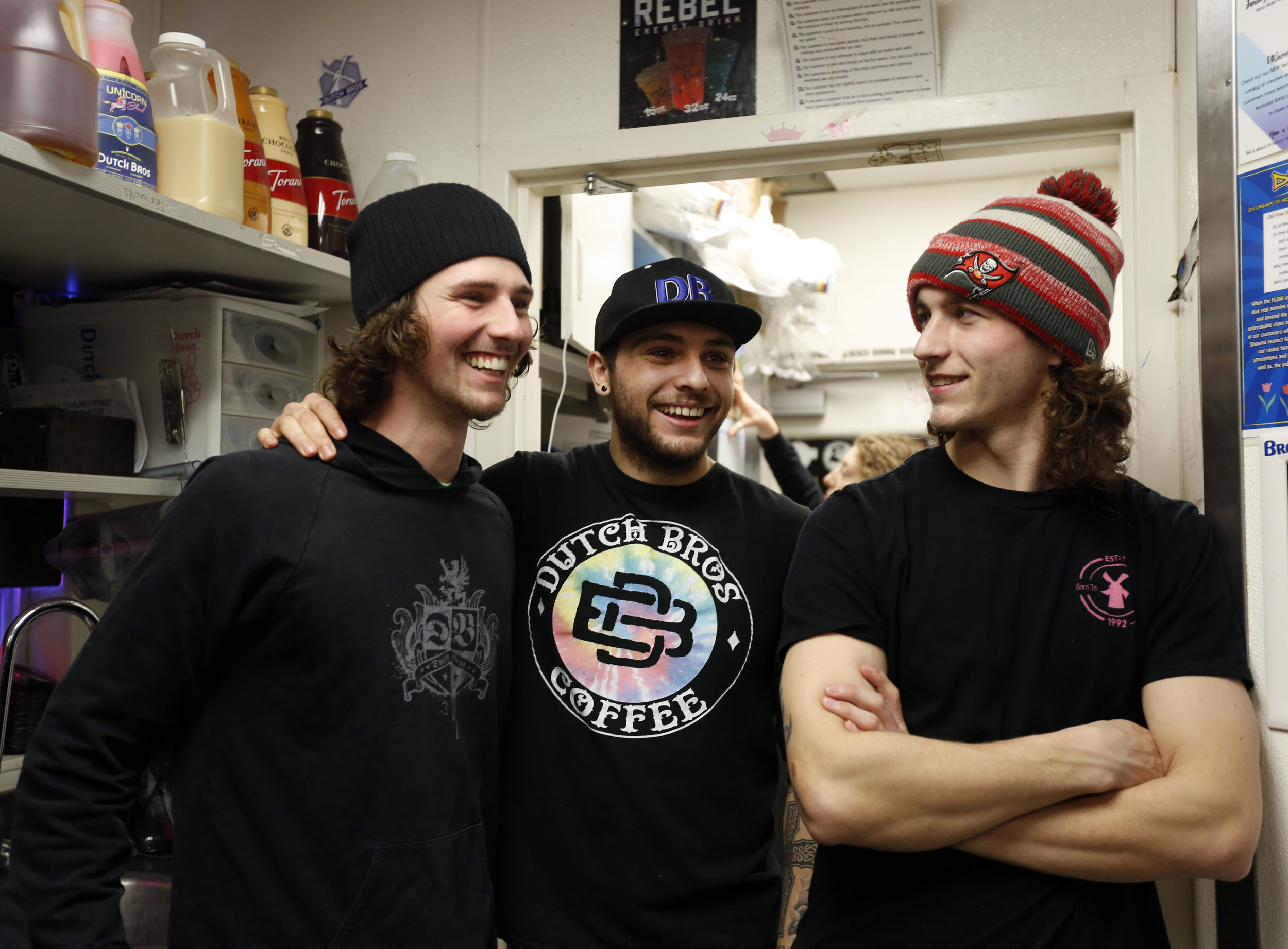   Co-workers Jake Daniels, left, and Garrit Farrell, right, stop to visit Zade Hakki while he’s working in Kennewick. For many who work at Dutch Bros., their co-workers become family and they spend many off-the-clock hours hanging out at the coffee s