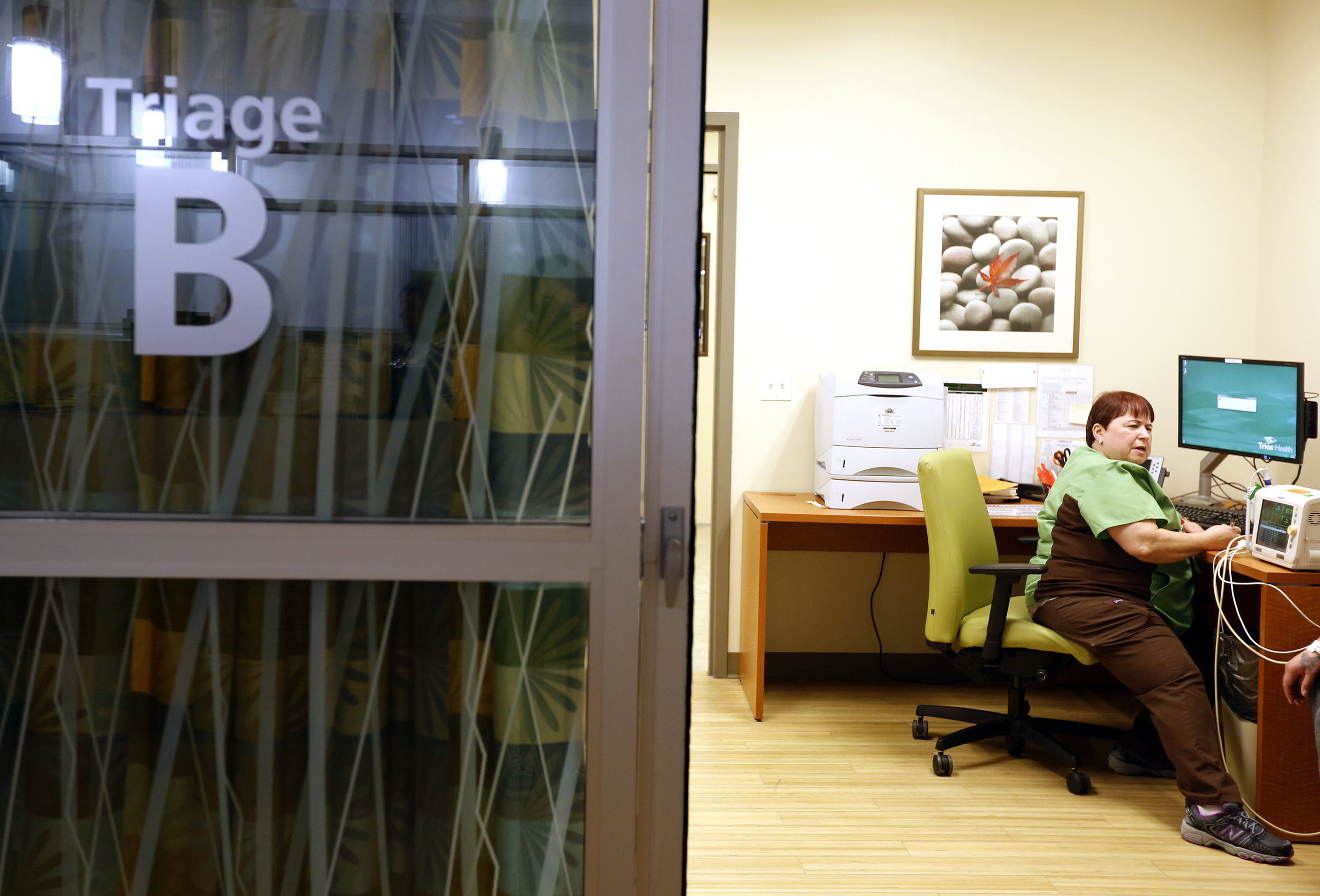   Patsy Haeg, an overnight charge nurse in the emergency department at Trios Southridge Hospital in Kennewick, talks with a patient during the 1 a.m. hour.     