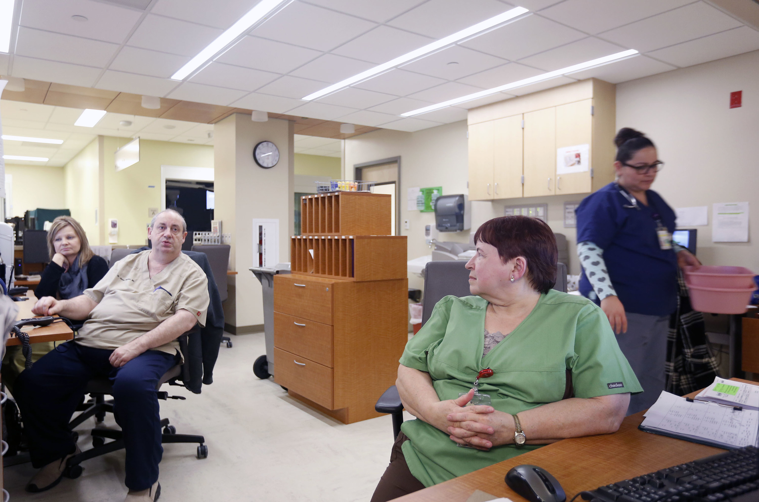   Patsy Haeg, an overnight charge nurse in the emergency department at Trios Southridge Hospital in Kennewick, talks with coworkers during the 1 a.m. hour  