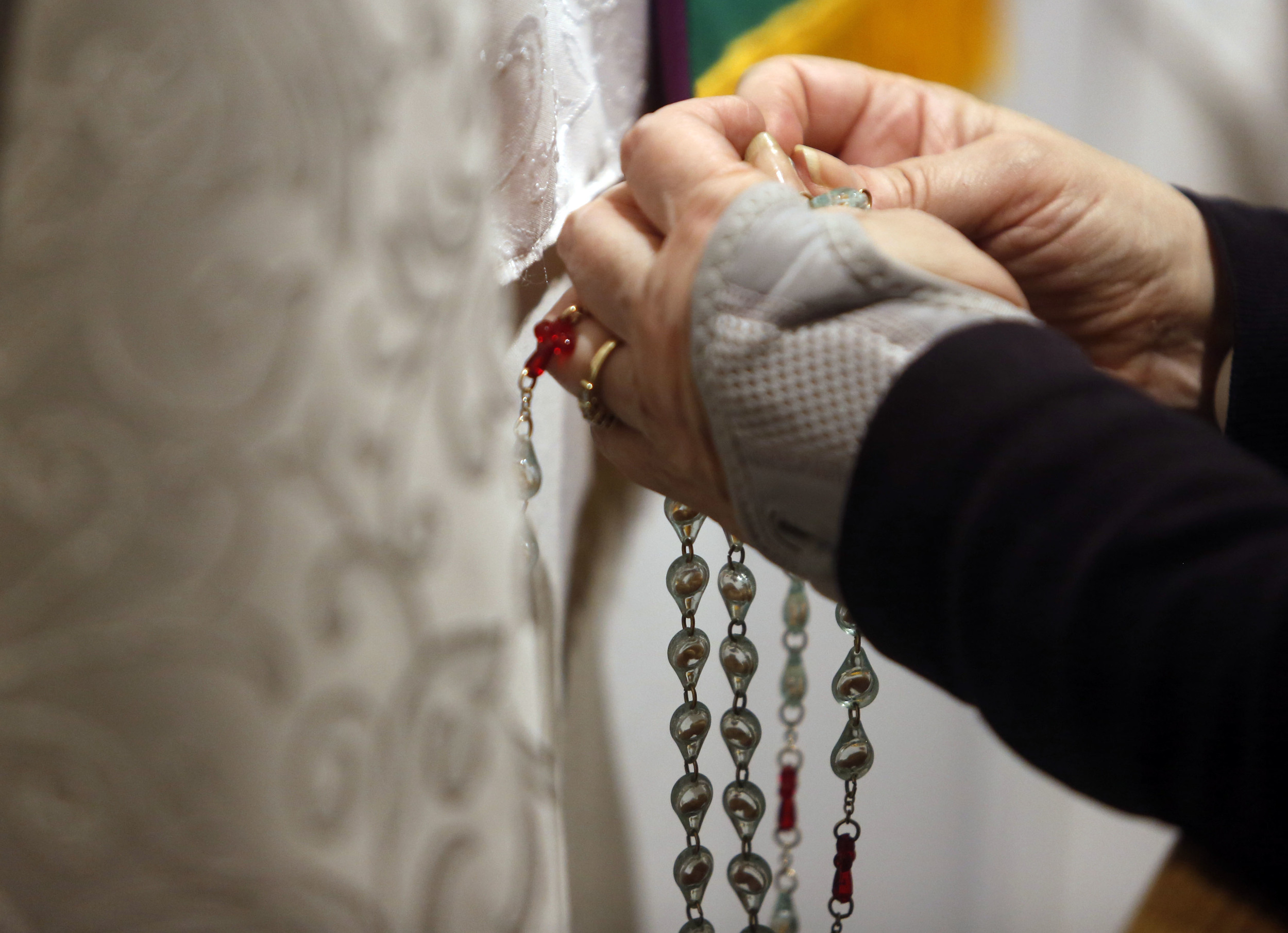   Carol LeCompte, 66, of Kennewick, holds rosary beads and prays in the perpetual adoration chapel at St. Joseph Catholic Church in Kennewick during the 2 a.m. hour.  