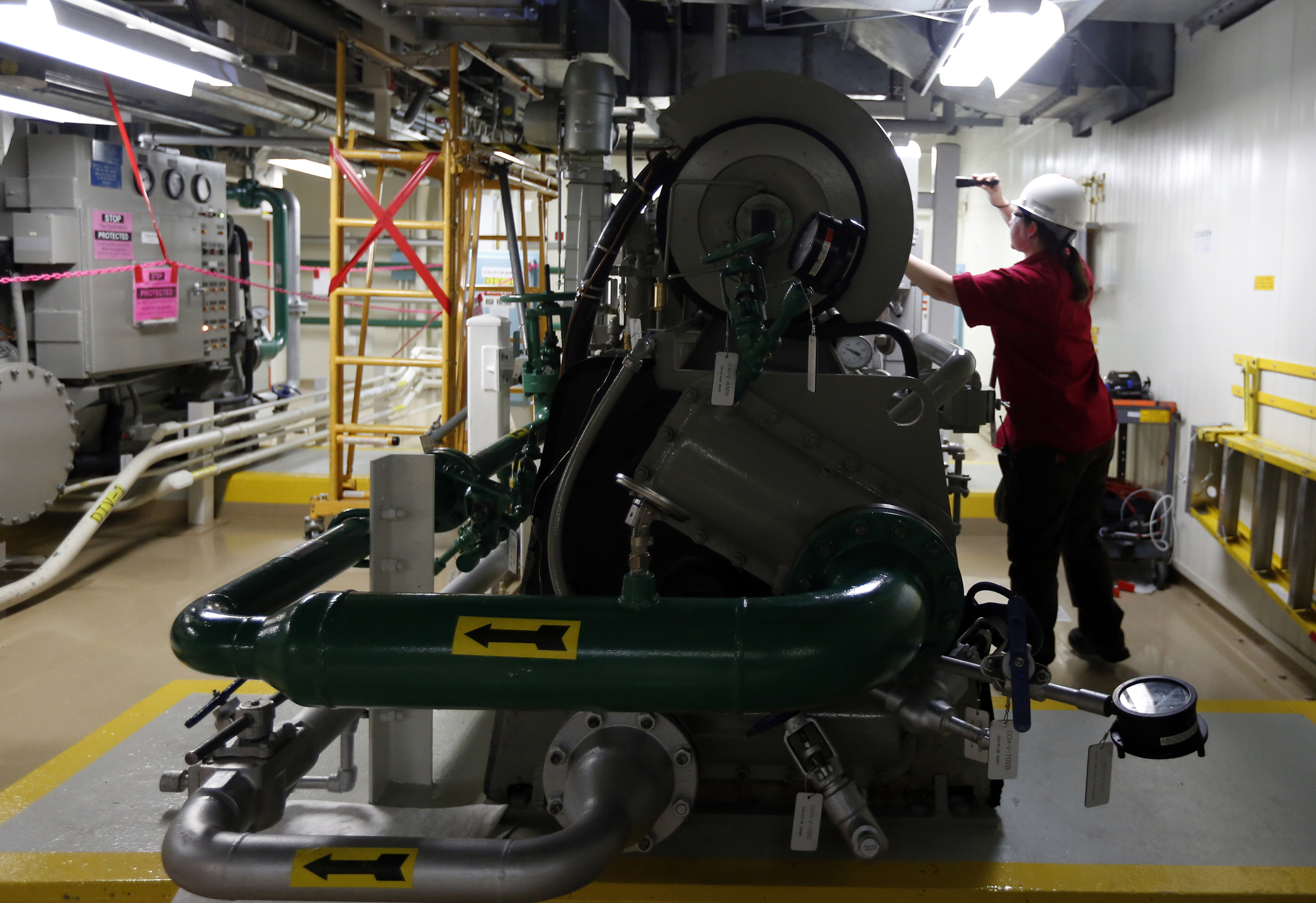   Angela Deahl inspects a piece of equipment during her overnight shift at the Columbia Generating Station near Richland.     