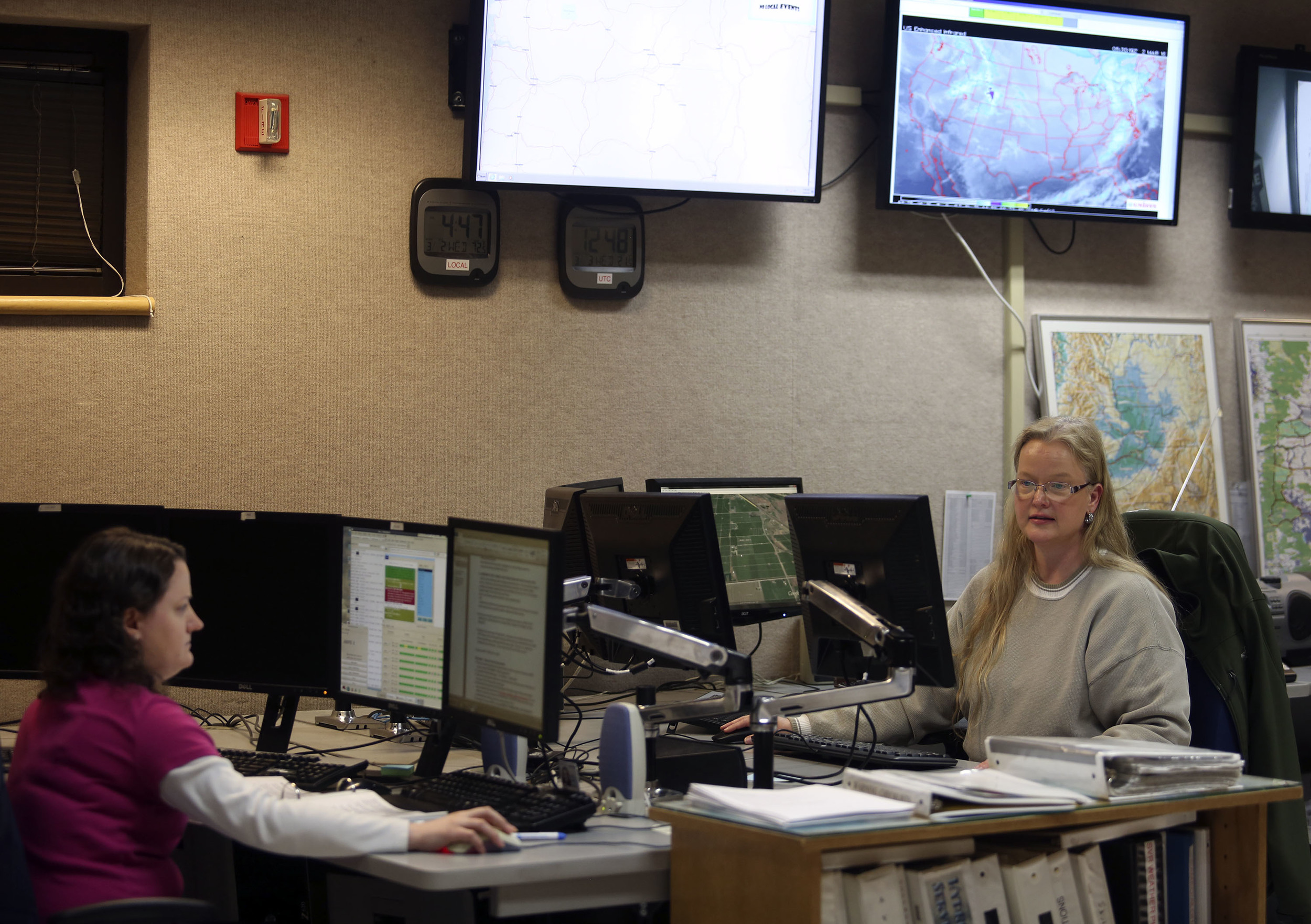   Meteoroligists Mary Wister, right, and Rachel Cobb work on forecasts during a recent overnight shift at the National Weather Service in Pendleton       