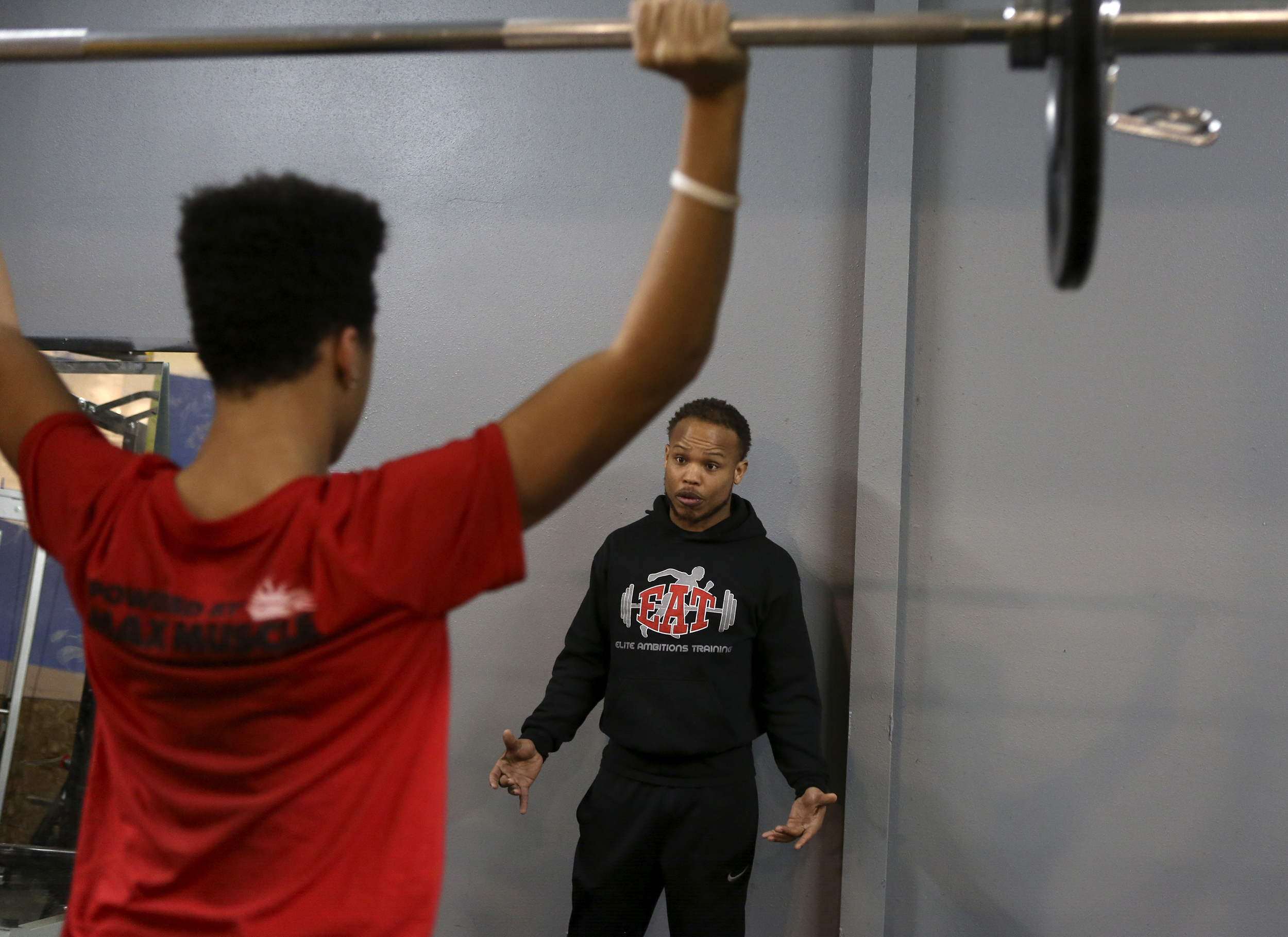   Steven Whitehead talks to Jordan Gray, a Kennewick High School junior, during a early morning training session with high school athletes at Elite Ambitions Training in Kennewick. Whitehead, founder and owner of E.A.T., came to Kenenwick in 2011 to 