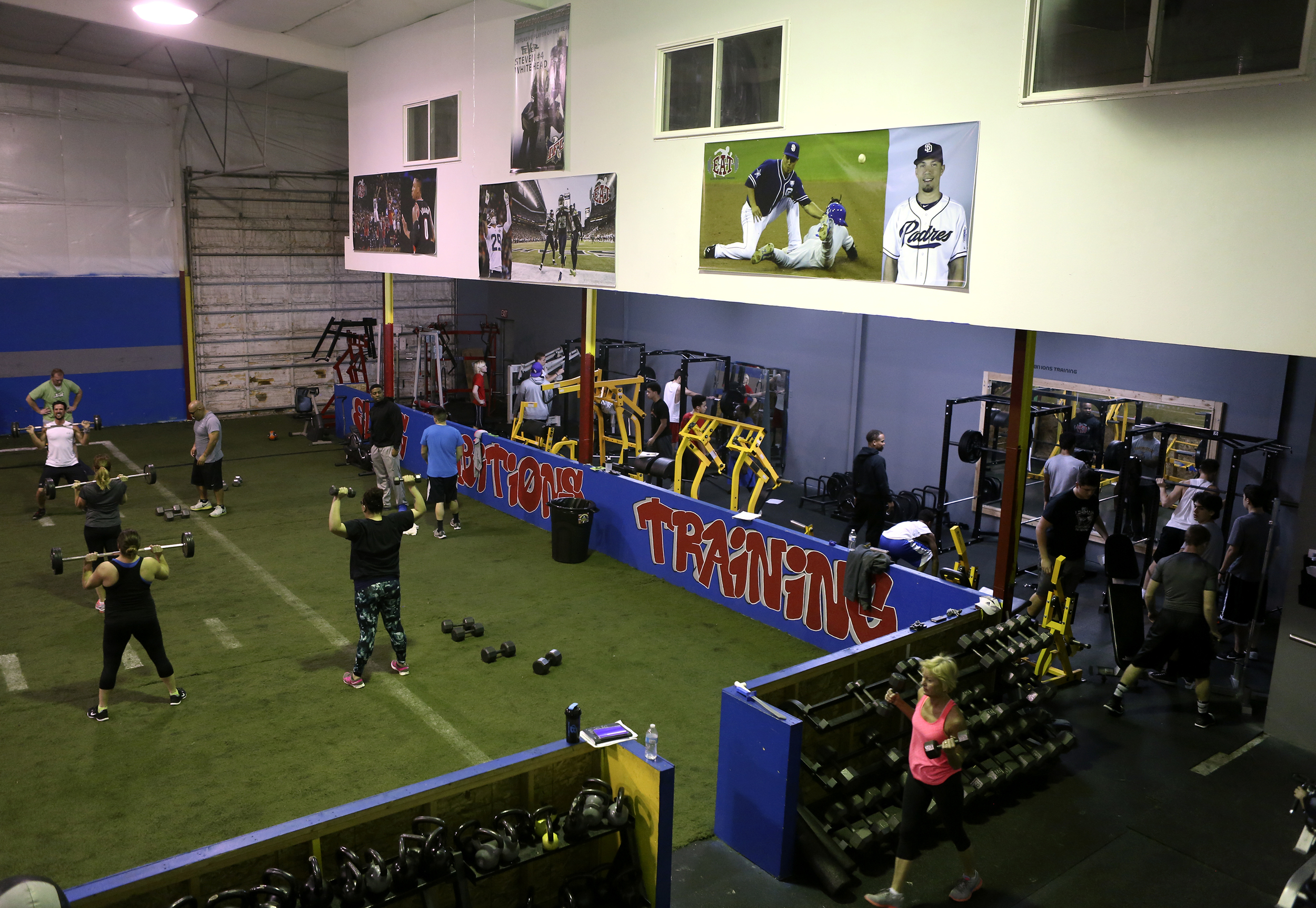  A photo of Steven Whitehead from his Tri-Cities Fever days hangs on the wall with other professional athletes during early morning fitness classes and weight training at Elite Ambitions Training in Kennewick. . &nbsp;Whitehead is the founder and own