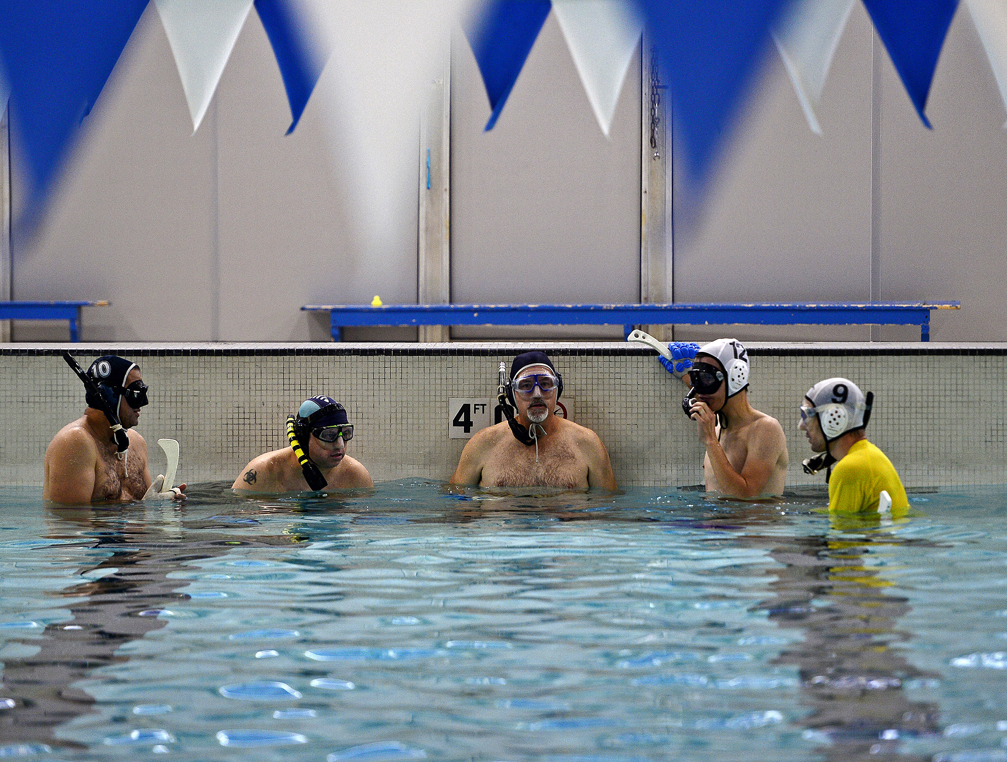  Teammates talk during a break of a pickup game with Southeast Connecticut Underwater Hockey on Sunday, September 9, 2018 at UConn Avery Point.  