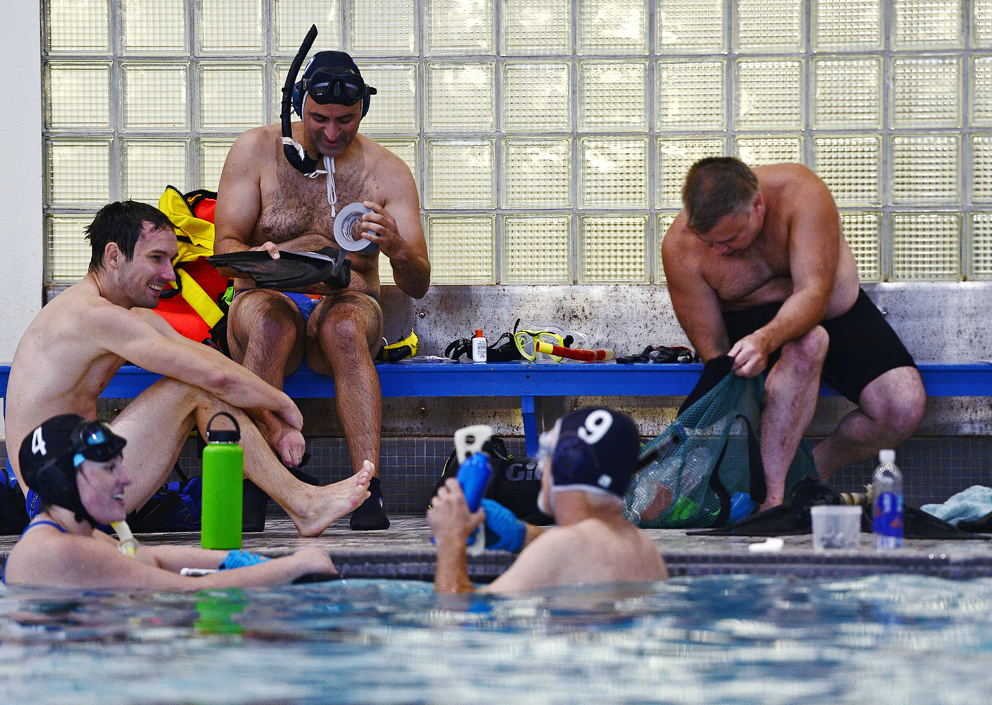  Swimmers tape their fins and adjust gloves as they get ready for a pickup game with Southeast Connecticut Underwater Hockey on Sunday, September 9, 2018 at UConn Avery Point. 