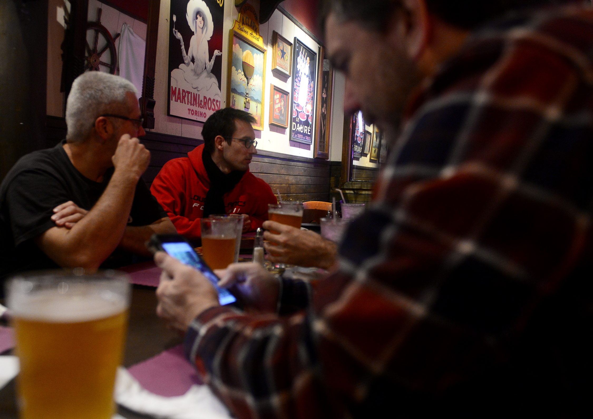  Teammates talk over beer and dinner at Sneekers Cafe, a weekly tradition, after a pickup game with Southeast Connecticut Underwater Hockey on Sunday, September 9, 2018.  