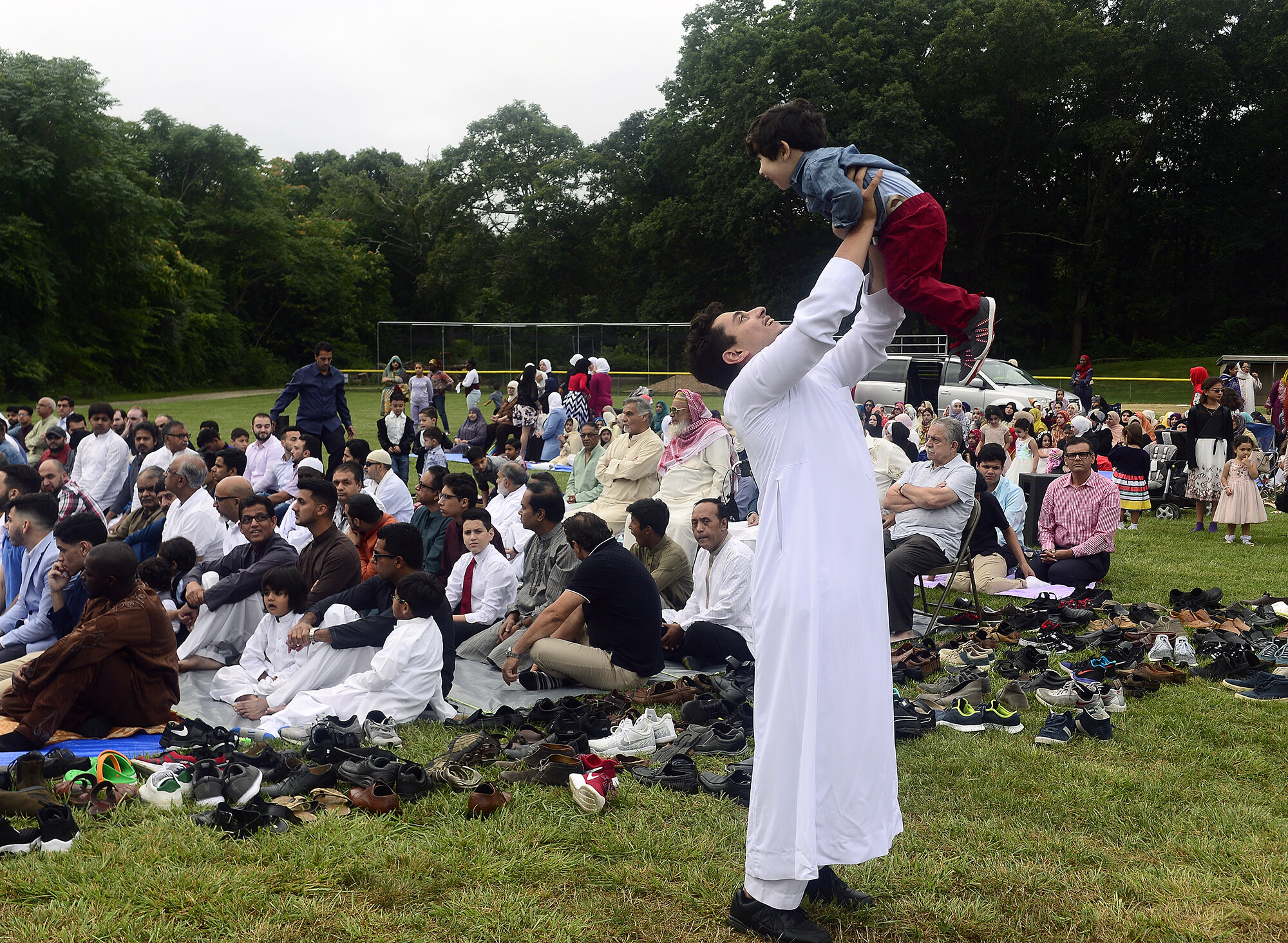  Adam Aboudawd celebrates with his cousin Eyad Alawi, 2, as members of the Islamic Center of New London gather for a prayer to celebrate Eid al-Adha on Tuesday, August 21, 2018 at Washington Park in Groton. The holiday, also referred to as the Festiv
