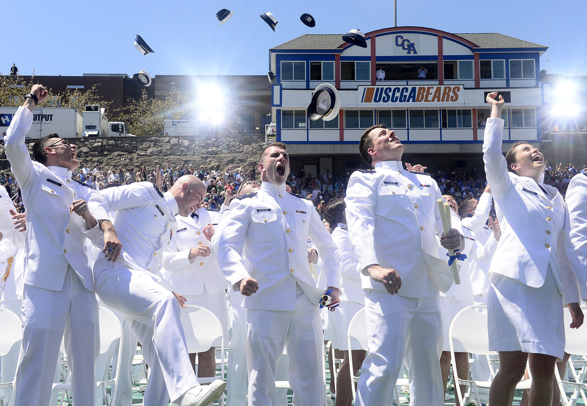  Graduates, from left, Nathaniel Matthews, William Maxam, Matthew McAllister, Frederick McClimans and Michaela McKeown react as they throw their hats in the air during the U.S. Coast Guard Academy's graduation for the class of 2017 at Cadet Memorial 