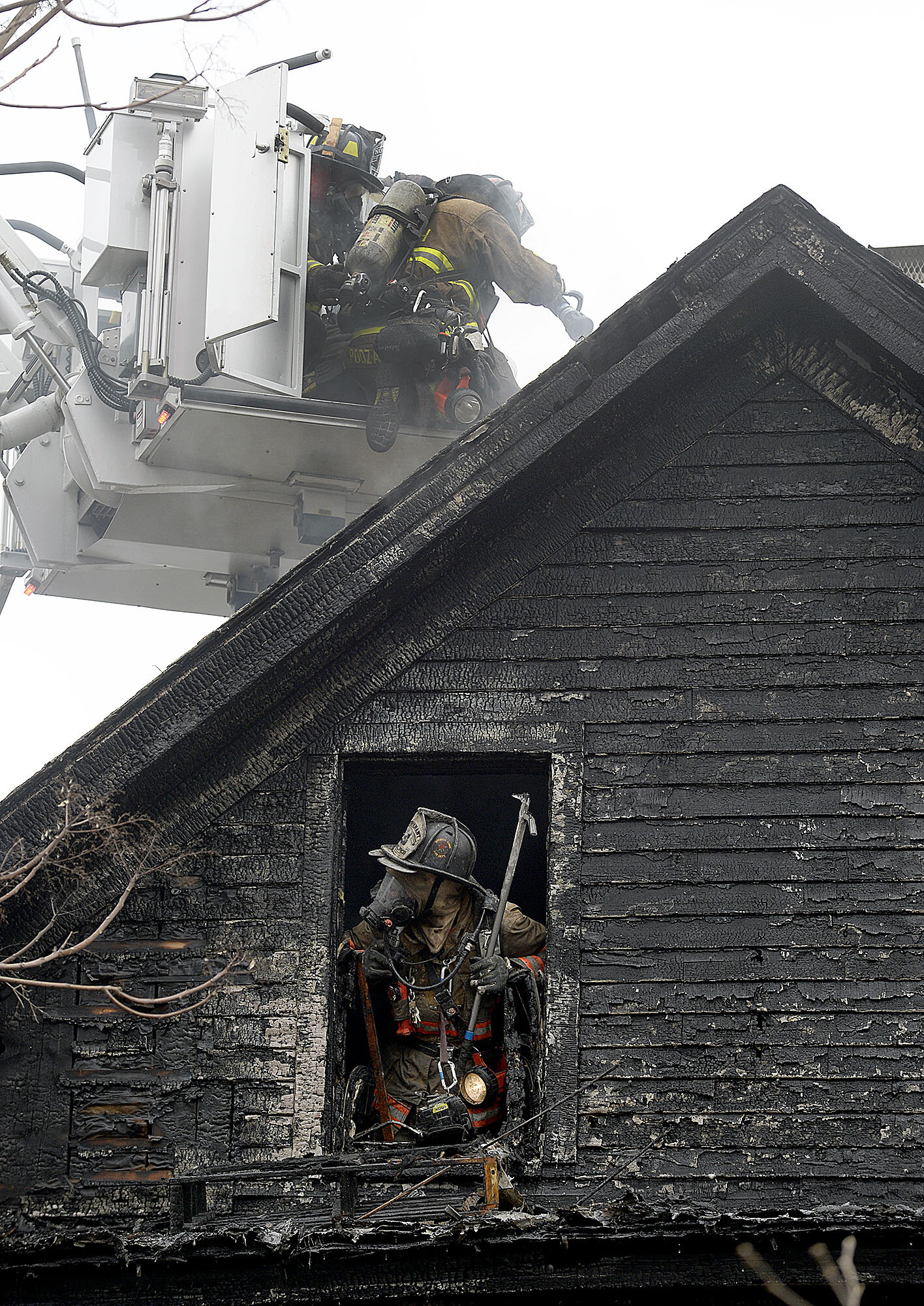  Firefighters work from the roof, in a bucket, and attic as several area fire departments fight a fire at 42 Prospect St. on Sunday, February 3, 2018 in Norwich. Everyone in the two-family home got out safely after the fire started shortly after 9 a.