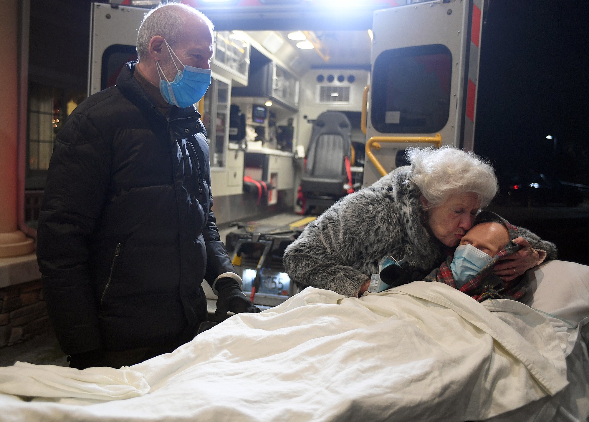  Sherry Wolfe says goodbye to her husband Harold Wolfe, 95, as their son Scott looks on after Harold was transported from Westerly Hospital to hospice at Mystic Healthcare Monday, January 10, 2022. The couple have been married for over 70 years and a